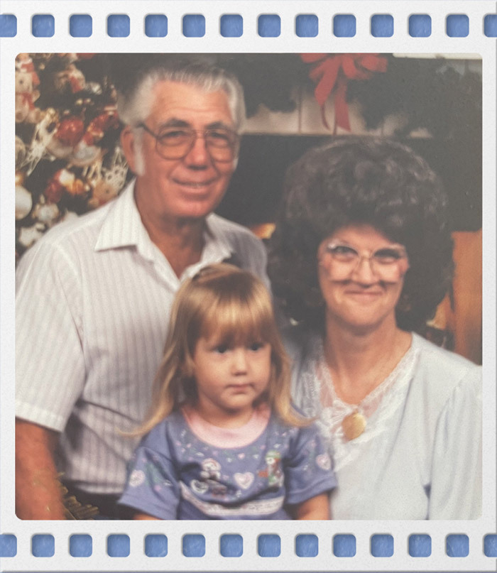 Family photo of Janice Hart posing with her husband & Ashley Hart